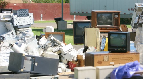Volunteers loading donated furniture for charity reuse from a clearance